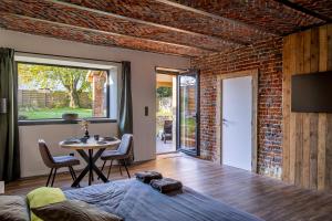 a room with a bed and a table with chairs at Wellnesshoeve in Boutersem