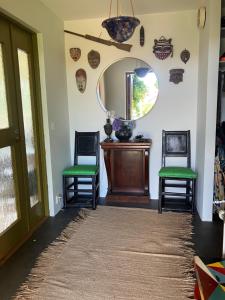 a hallway with two chairs and a mirror at Bra familjeboende Vitaby in Vitaby