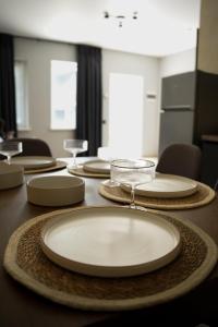 a table with white plates on top of it at Sea Cloud Hotel in Zatoka