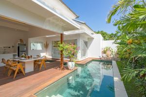 a backyard with a swimming pool and a house at Villa Lior - 1BR Luxury Hideaway near Nyanyi Beach in Canggu