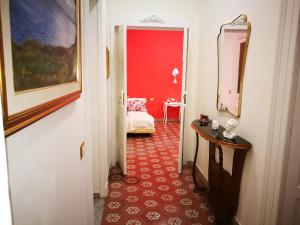a hallway with a room with a red wall at B&B Resta Cu Mme in Naples