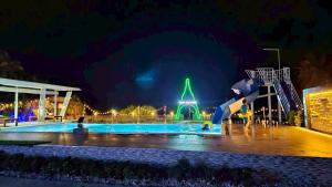 a pool at night with a water park at Nara Paradise Beach in Narathiwat +131 photos