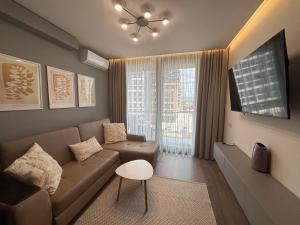 a living room with a couch and a window at Parkr Land Elite in Uzhhorod