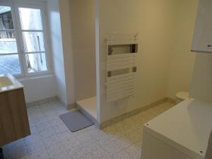 a white bathroom with a toilet and a window at CASTEL HOME in Châteaubourg +24 photos