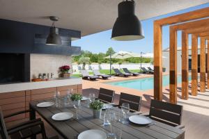 a dining room with a table and a pool at Villa Royal Green - Happy Rentals in Labin