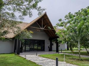a building with a gambrel roof and glass doors at Bon Hotel Crown Forest in Nsuaem