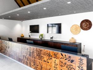 a lobby with a reception desk with a counter at Bon Hotel Crown Forest in Nsuaem