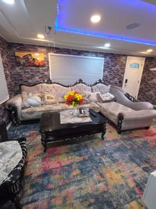 a living room with two couches and a table at Berwyn Alimot Proshortlet-home LLC in Syracuse