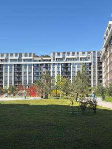 a park with a large building in the background at Parkr Land Elite in Uzhhorod