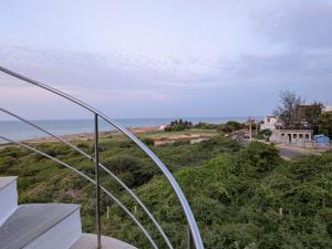 a view of the ocean from the balcony of a house at ANV Beach house in Kovakulam