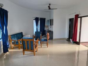 a living room with chairs and a table at ANV Beach house in Kovakulam +30 photos