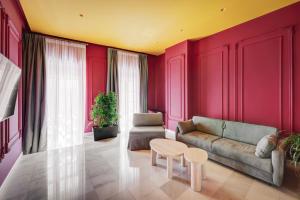 a living room with a couch and a table at ATELIER5 Suites in Ermoupoli