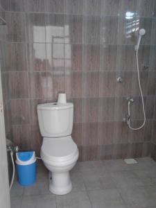 a bathroom with a toilet and a shower at Arcade Beach Hotel in Induruwa
