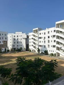 a group of white apartment buildings with a park at BMW Buxton point Apartment in Mombasa