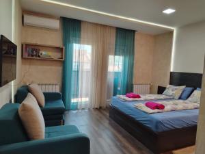 a living room with two beds and a couch at Apartman Harmony 5 in Banja Koviljača
