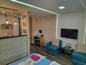 a living room with a couch and a tv at Apartman Harmony 5 in Banja Koviljača +17 photos