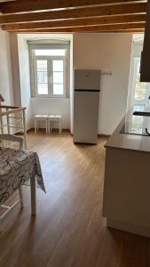 a kitchen with a refrigerator in the middle of a room at casa 20 centro in Lagos