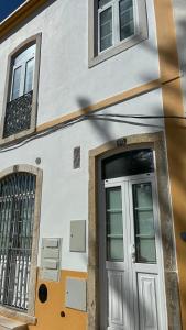 a white building with a door and windows at casa 20 centro in Lagos