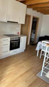 a kitchen with white cabinets and a stove top oven at casa 20 centro in Lagos +5 photos