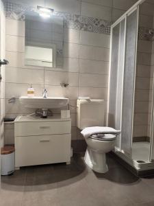 a bathroom with a toilet and a sink at NiceStay in Lugano