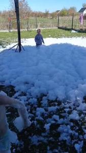 a person standing on top of a pile of snow at Domki Letniskowe BŁĘKIT in Gąski