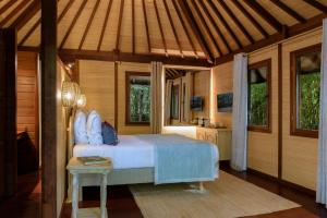 a bedroom with a bed and a table in a room at Domaine Les Mésanges in Saint-Tropez