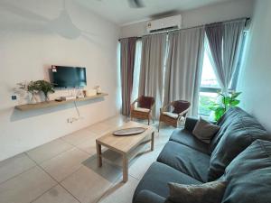 a living room with a couch and a table at Meritus Seaview Apartment in Perai