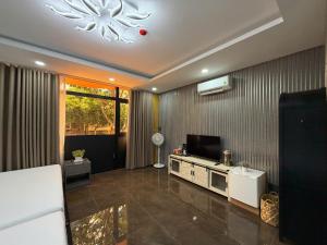 a living room with a flat screen tv on a wall at Kim's Hotel in Buon Ma Thuot