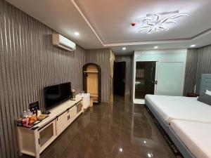 a bedroom with a bed and a flat screen tv at Kim's Hotel in Buon Ma Thuot +27 photos