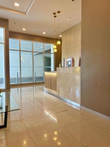 a hotel lobby with a tower sign on the wall at Avida Aspira Studio, 27th Floor, Pool & Gym in Cagayan de Oro