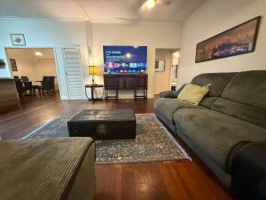a living room with a couch and a flat screen tv at Huge comfy 4br home near CBD in Geraldton