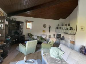 a living room with a white couch and chairs at Pedecosta in Poschiavo
