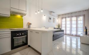a kitchen with white cabinets and a white counter top at Monamie-Windsor Park in Adeje