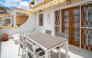 a wooden table and chairs on a patio at Monamie-Windsor Park in Adeje