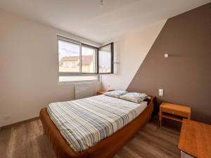 a bedroom with a bed and a window at Appartement Lily-rose in Cerizay