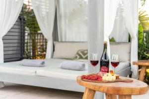 a table with two glasses of wine and cheese at Arfna Grand Villa in Afantou +44 photos