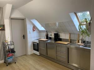 a large kitchen with stainless steel appliances and a window at Ferienwohnung Ankerplatz in Rankwitz