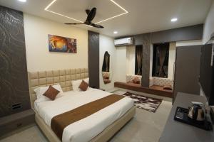 a bedroom with a bed and a ceiling fan at Hotel Ace Inn in Dr. Babasaheb Ambedkar International