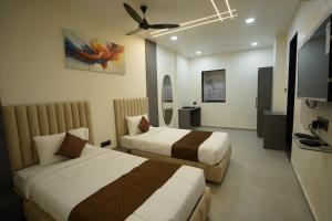 a hotel room with two beds and a television at Hotel Ace Inn in Dr. Babasaheb Ambedkar International +23 photos