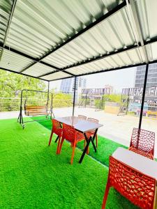 a patio with a table and chairs and a playground at Hotel Sulin Prahladnagar in Ahmedabad