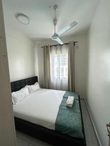 a bedroom with a bed and a window at BMW Buxton point Apartment in Mombasa +44 photos