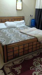 a bedroom with a large bed with ayth at Shubharohi stay in Chhatikara