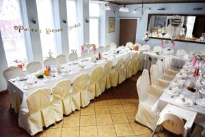 a banquet hall with white tables and white chairs at Pokoje Gościnne & Apartamenty Przemyk in Rewa