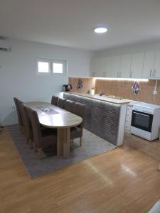 a kitchen with a table and chairs and a counter at Drinska kućica in Ljubovija