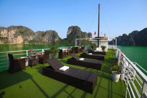 a boat with tables and benches on the water at Sunlight Legend Cruise in Ha Long