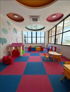 a room with a playroom with colorful floors and tables at Torre meridt in Santo Domingo +54 photos