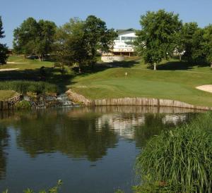 a view of a golf course with a pond at Tan-Tar-A Estates in Damsel