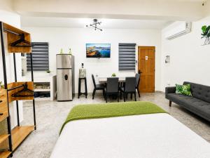 a living room with a couch and a table at Cabo Downtown Studios in Cabo San Lucas