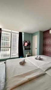 a large white bed in a room with a window at Bright Hotel in Petaling Jaya +53 photos