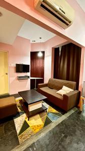 a living room with a couch and a table at Bright Hotel in Petaling Jaya